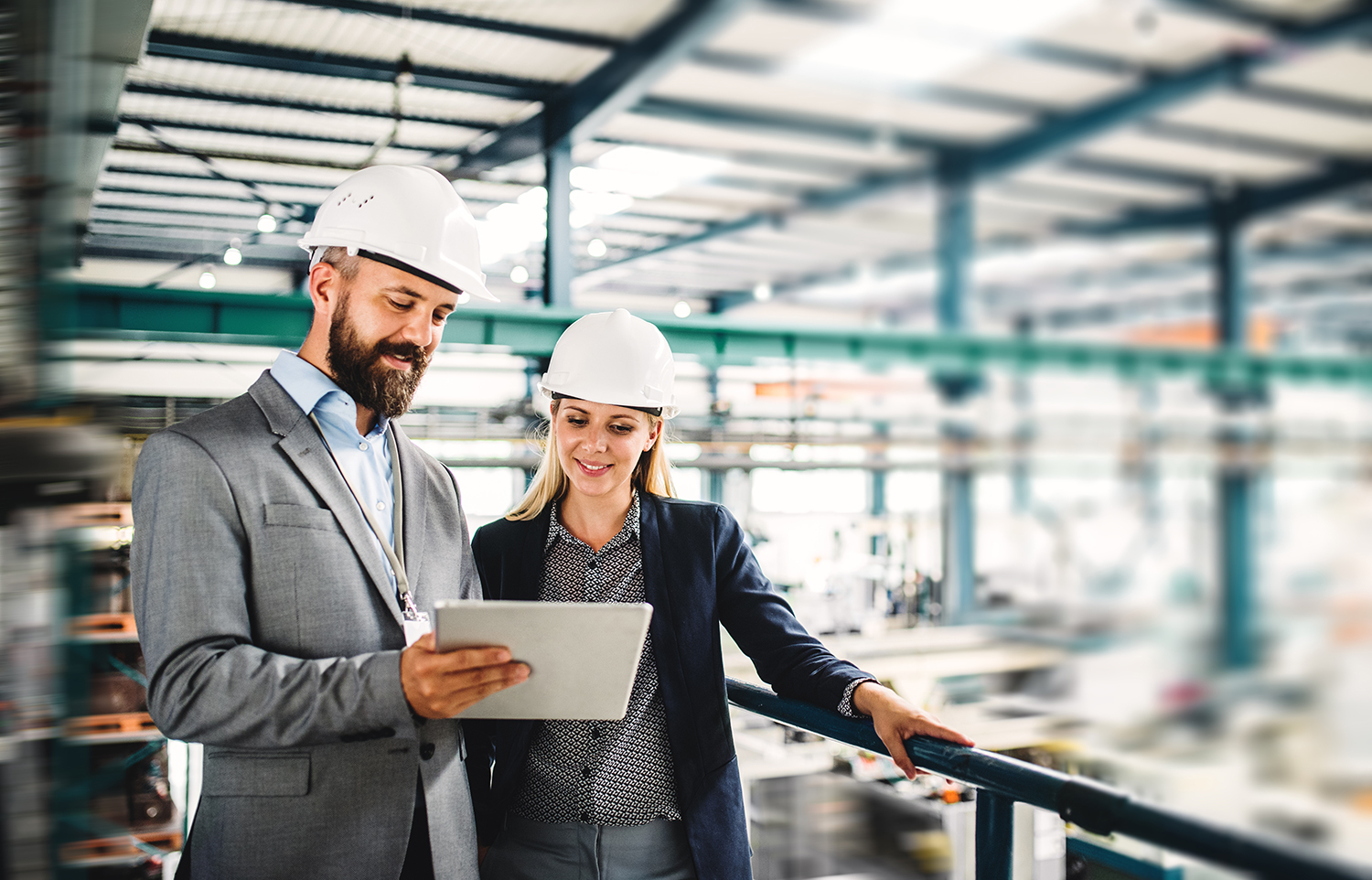 Two engineers looking at an Apple iPad at a job site