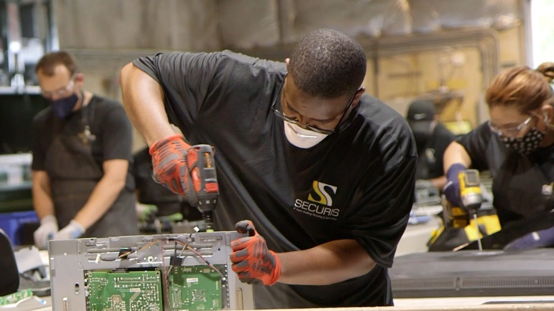 Securis Employee using a drill to assemble a computer